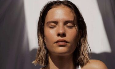 woman face with eyes closed in sun