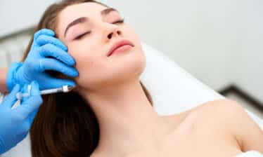 woman receiving botox injections in jaw