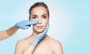 surgeon examine woman nose